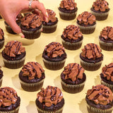 Vegan Chocolate Cupcakes with rich chocolate sponge, plant-based buttercream, and chocolate drizzle from Crumbs & Doilies.